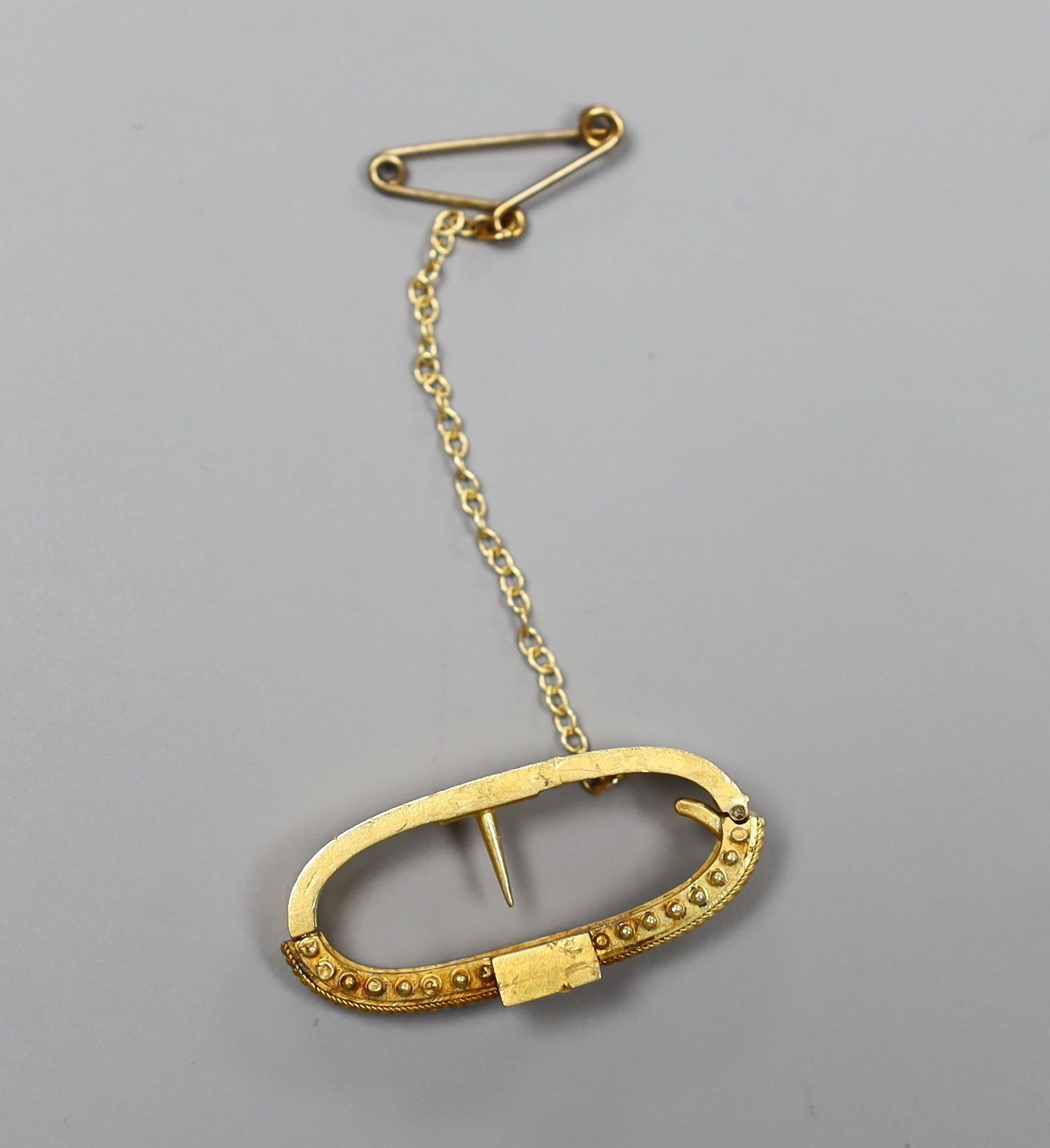 A Victorian yellow metal and diamond set scarf clip, 28mm, gross 4.3 grams.